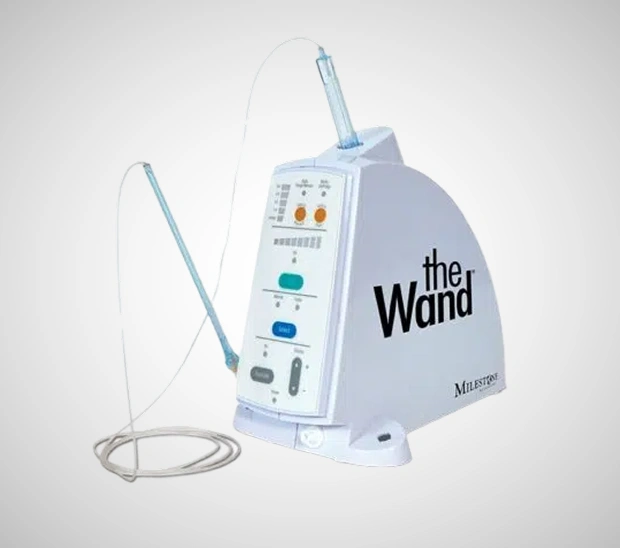 The Wand dental anesthetic delivery system with handpiece and tubing displayed on white background.
